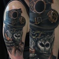 Realism style colored shoulder tattoo of gorilla with mechanical hat and smoking pipe