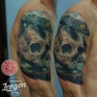 Realism style colored shoulder tattoo of human skull and lizard