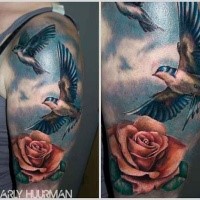 Realism style colored shoulder tattoo of flying birds with rose