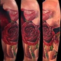 Realism style colored shoulder tattoo of red rose with vampire mouth