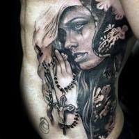 Realism style colored side tattoo of praying woman with cross