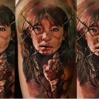 Realism style colored tattoo of sad little girl with fence