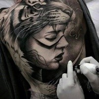 Realism style colored whole back tattoo of woman with tiger helmet