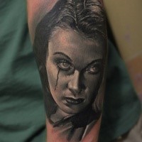 Realism style detailed arm tattoo of creepy looking woman