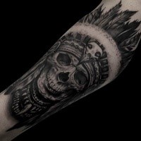 Realism style detailed arm tattoo of Indian skull with feather