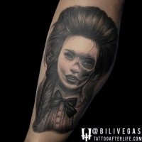 Realism style detailed black and white leg tattoo of woman stylized with skull