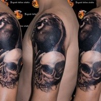 Realism style detailed shoulder tattoo of woman with human skull and leaves