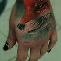 Realism style lifelike colored hand tattoo of smiling fox
