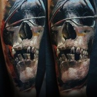 Realism style mystical looking human skull tattoo stylized with dark triangle