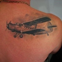 Realism style very detailed scapular tattoo of vintage plane