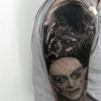 Realism style very detailed shoulder tattoo of werewolf and vampire