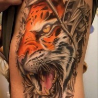 Realistic colorful tiger in a thicket tattoo on ribs