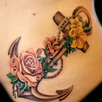 Realistic detailed anchor with roses tattoo on ribs