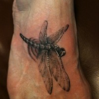 Realistic dragonfly tattoo on foot