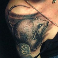 Realistic gray-ink rodent tattoo on shoulder