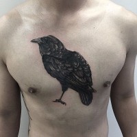 Realistic lifelike medium size black crown detailed tattoo on chest