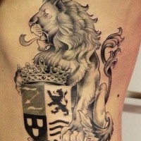 Realistic lion with family crest and crown tattoo on ribs