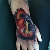 Realistic looking 3D like half skull half heart tattoo on hand