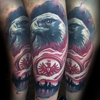 Realistic looking arm tattoo of eagle with city sights and emblem
