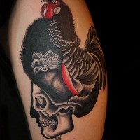 Realistic looking big chicken with skull tattoo on shoulder area