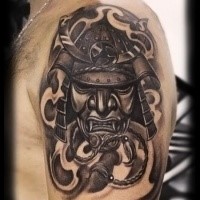 Realistic looking black and gray style shoulder tattoo of samurai mask and fog