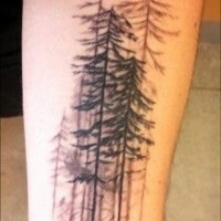 Realistic looking black ink old forest tattoo on arm