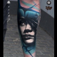 Realistic looking colored arm tattoo of woman face