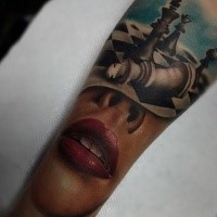 Realistic looking colored arm tattoo of woman leaps and chess