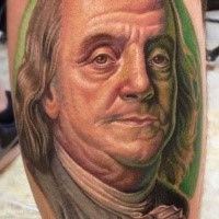 Realistic looking colored leg tattoo of Benjamin Franklin portrait