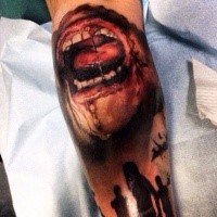 Realistic looking colored leg tattoo of zombie human mouth