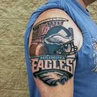 Realistic looking colored shoulder tattoo of sports team emblem