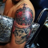 Realistic looking colored shoulder tattoo of skull with crown