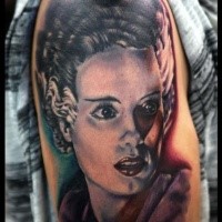 Realistic looking colored shoulder tattoo of vintage woman portrait