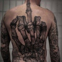 Realistic looking detailed whole back tattoo of skeleton hand