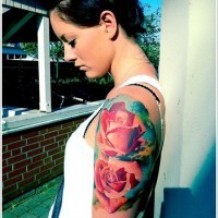 Realistic looking massive roses tattoo on shoulder