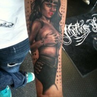 Realistic looking nice painted and detailed seductive naked woman tattoo on arm