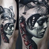 Realistic looking portrait style thigh tattoo of woman portrait with wolf and ornaments