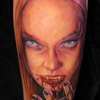 Realistic painted and colored creepy bloody vampire woman tattoo on arm