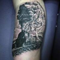 Realistic photo like black and white old steamy train tattoo on leg