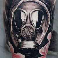 Realistic photo like black ink person in gas mask tattoo on arm