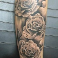 Realistic roses with dew drops forearm tattoo