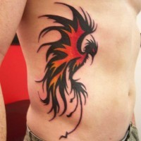 Red and black phoenix tattoo on ribs