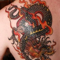 Red dragon tattoo on shoulder blade