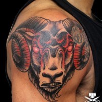 Red ram tattoo on man's shoulder