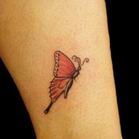 Red small butterfly tattoo on womans body