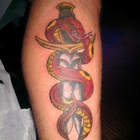 Red snake on dagger tattoo on leg