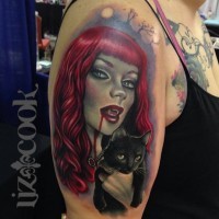 Redhaired vampiress with black cat tattoo on shoulder by Liz Cook