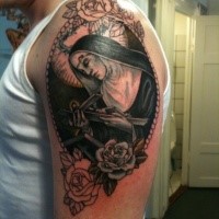 Religious style colored mother with cross and flowers tattoo on upper arm