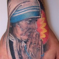Religious themed colored praying woman tattoo on hand