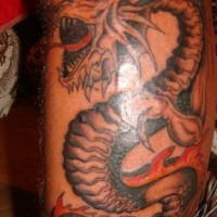 Roaring dragon tattoo on leg